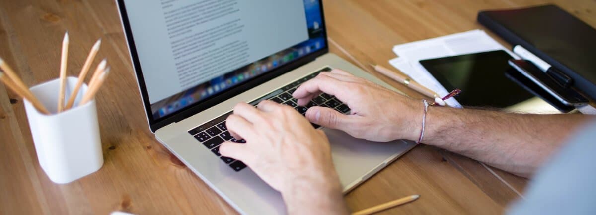 freelance copywriter typing on laptop