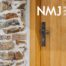 Close up of wooden door with NMJ logo