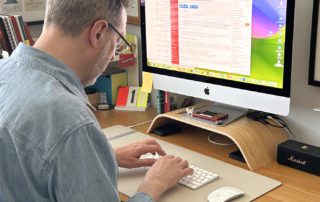 Graeme Piper writing copy at his desk